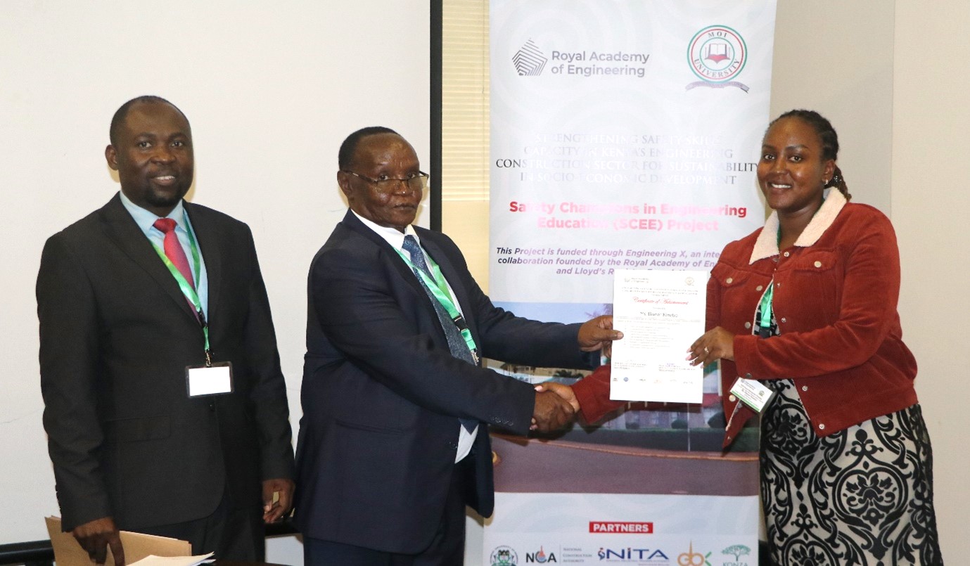 The DVC, Prof. Kimengi issuing a certificate of completion to a graduate intern
